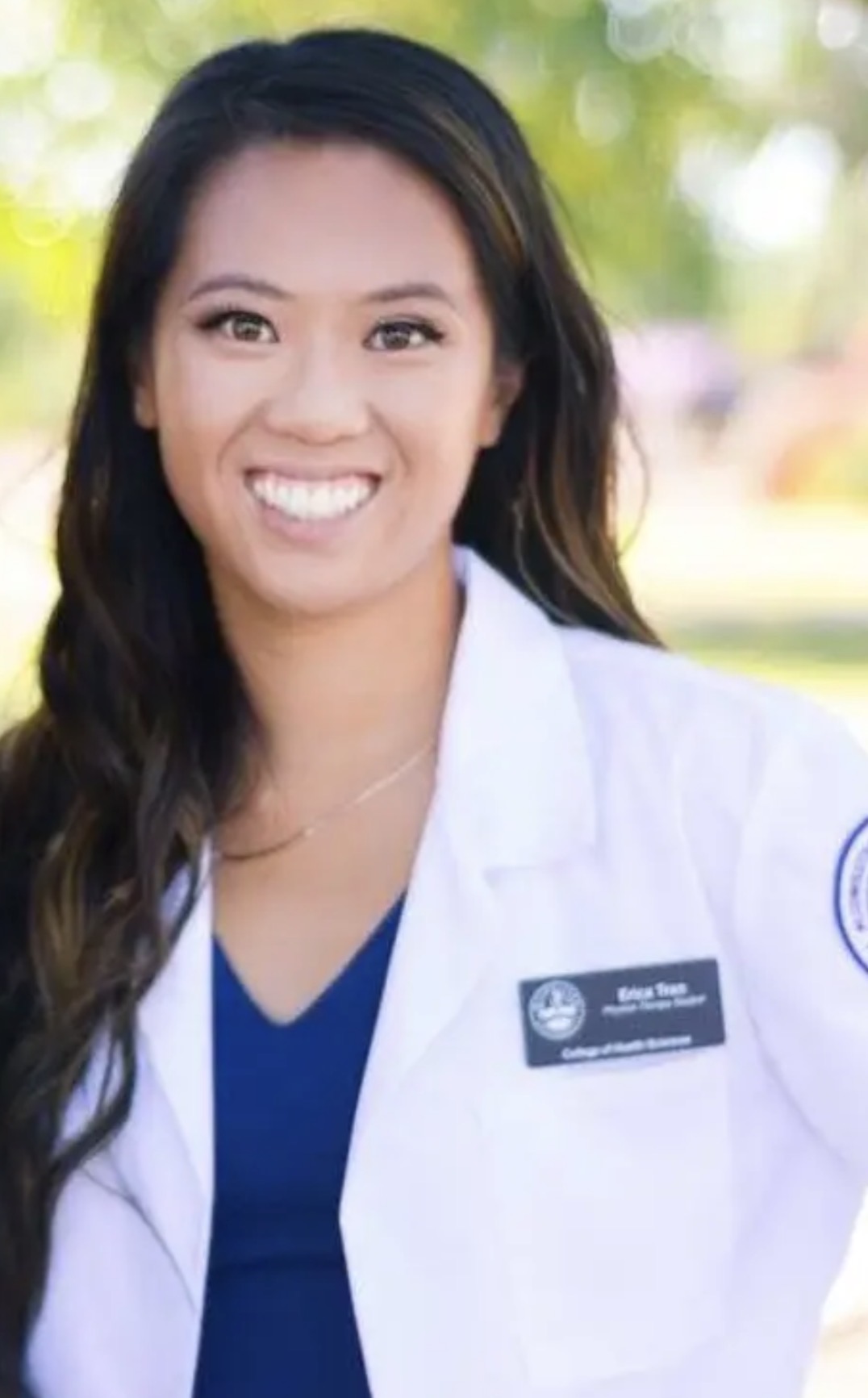 Dr. Erica Tran, PT, DPT in her white coat